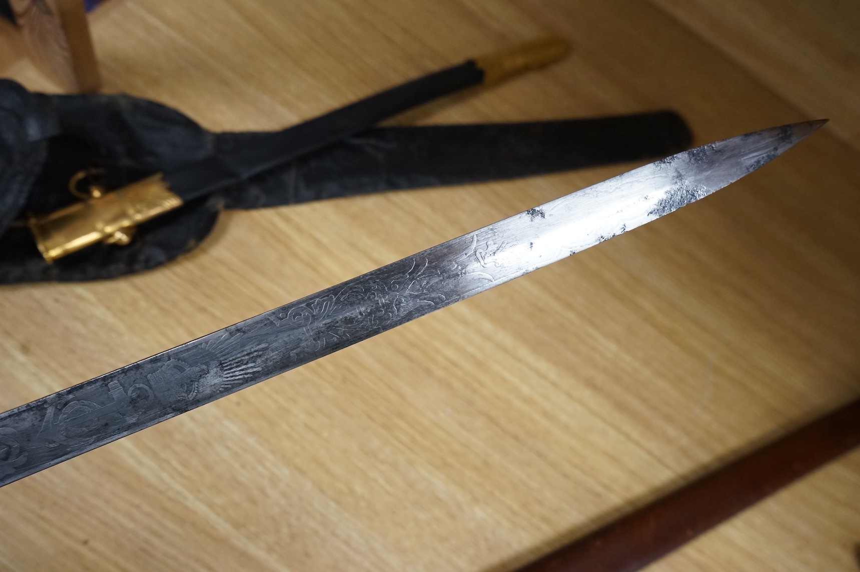 A post 1902 regulation Naval Officer’s dirk with lion’s head pommel, bullion dress knot, shark skin covered grip, in its leather scabbard, the gilt locket engraved with owners initials; CHCO’ R, the blade etched with cro